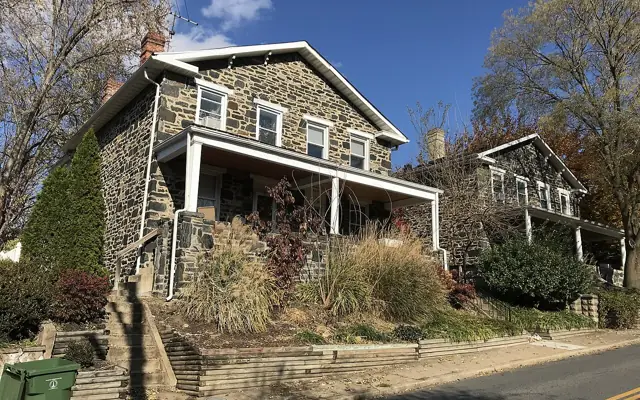 Stone duplex homes with front porches